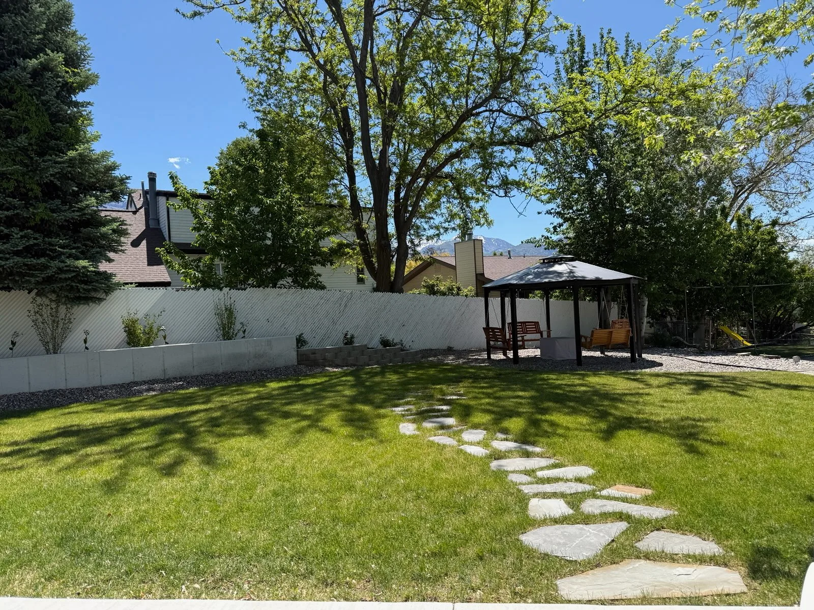 Finished Utah backyard with gazebo, lawn, and hardscape