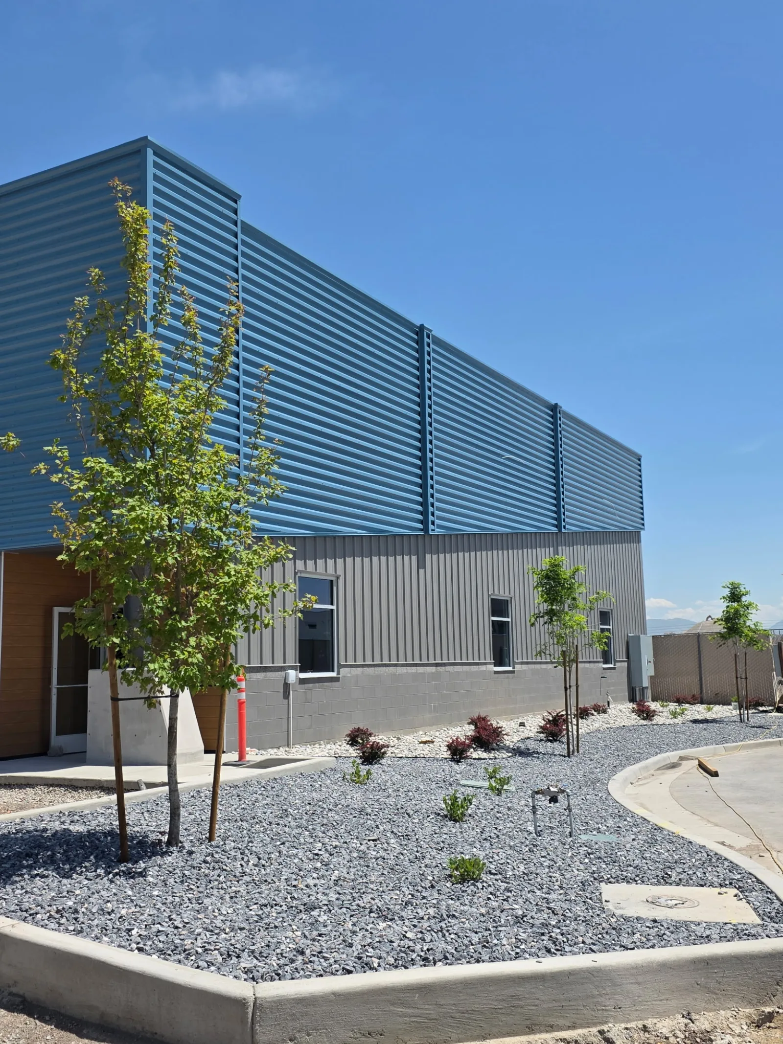 Commercial property landscaping with trees and decorative rock